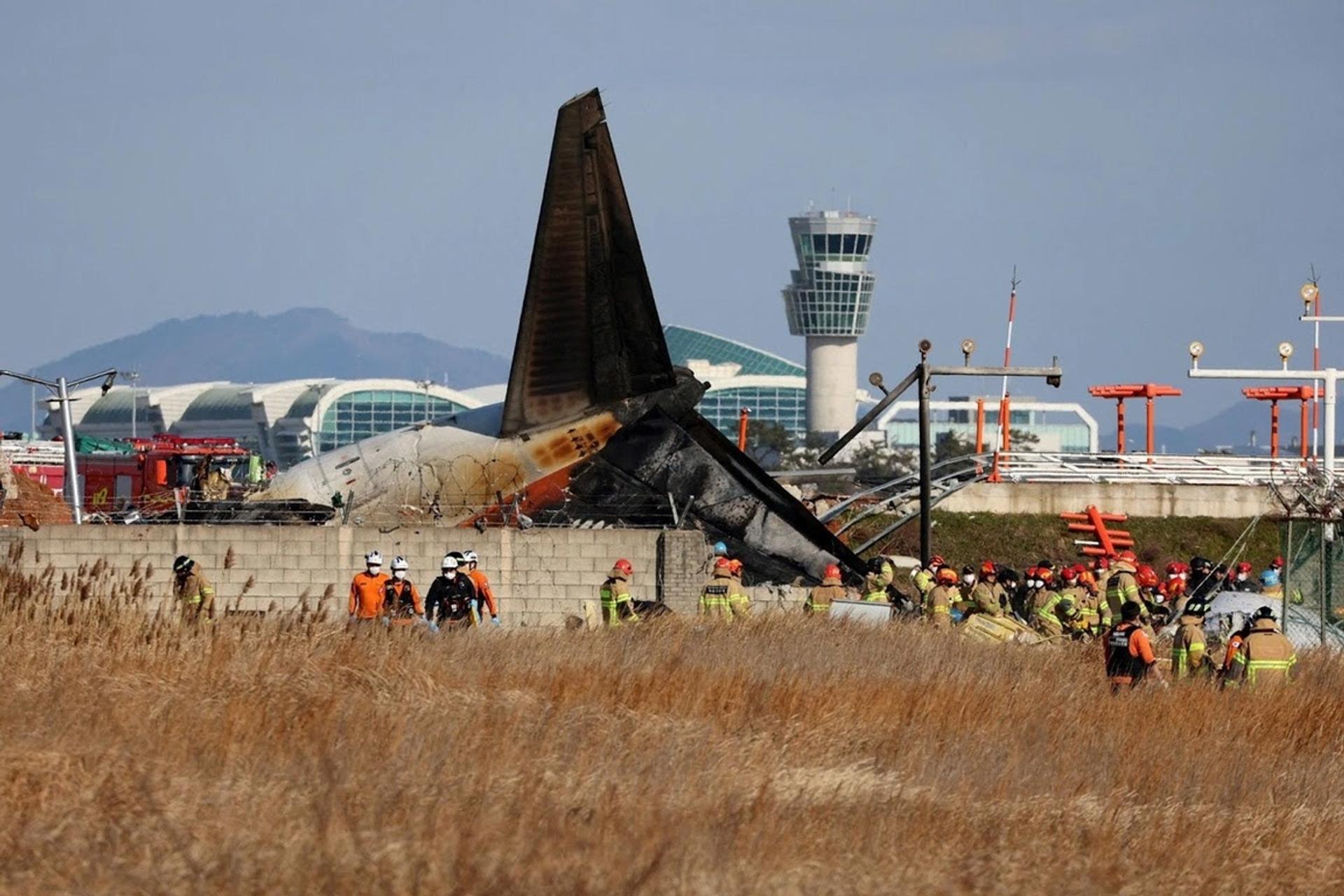 Firefighters surround the site of a plane crash at Muan international airport