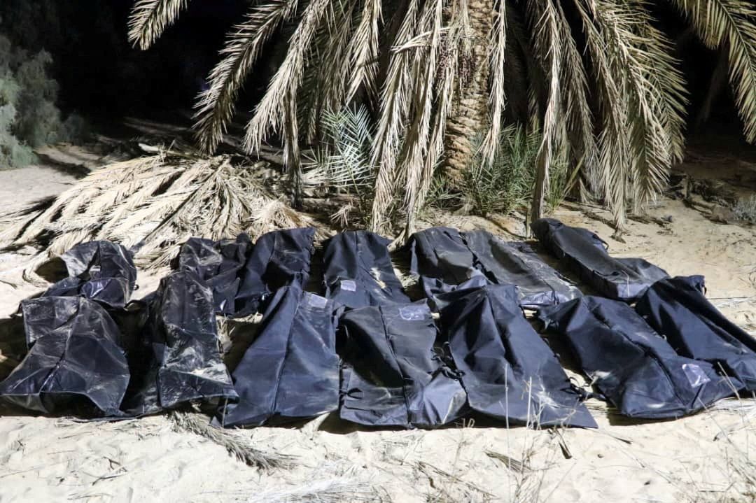 Bodies of migrants lie in bags after being discovered in a mass grave in Libya