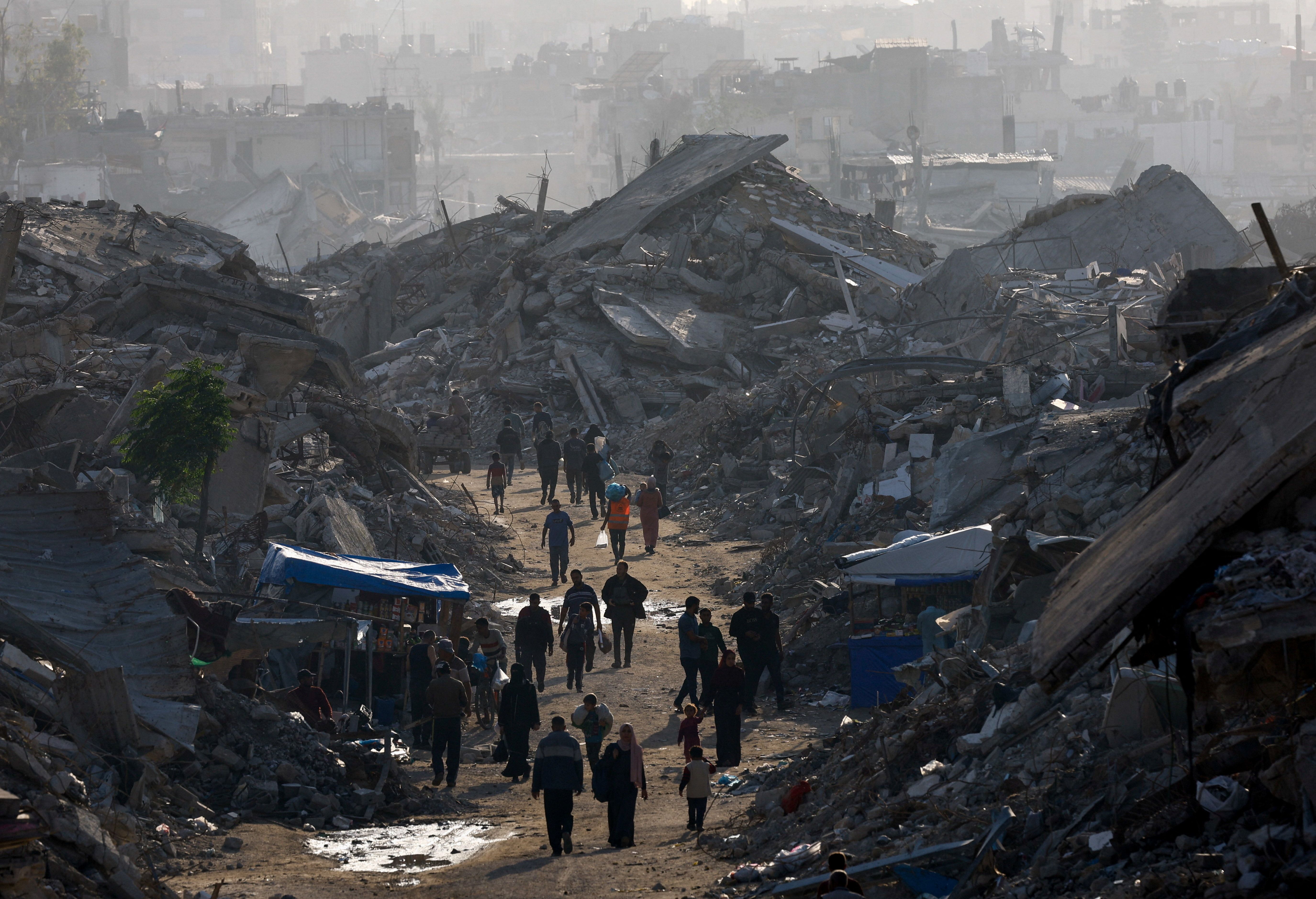 Gazans walk amid destroyed structures