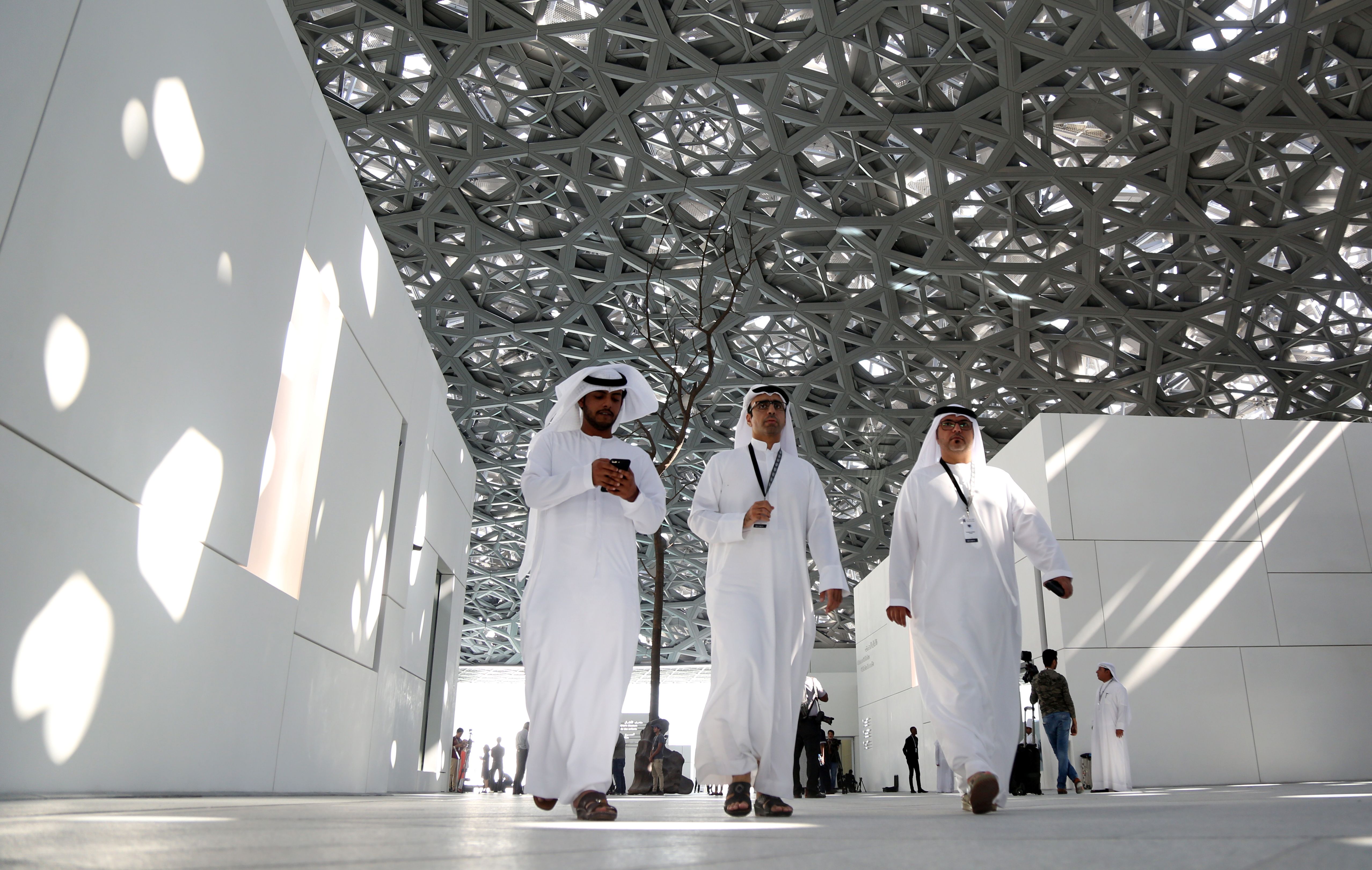 People walk at the Louvre Abu Dhabi in Abu Dhabi, United Arab Emirates.