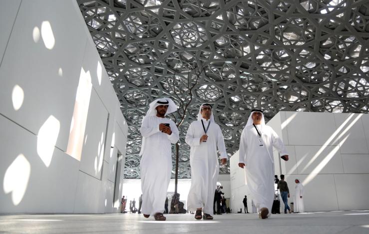 People walk at the Louvre Abu Dhabi in Abu Dhabi, United Arab Emirates.