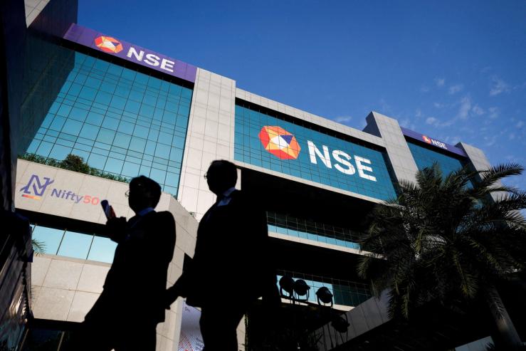 People walk outside the National Stock Exchange (NSE) in Mumbai.