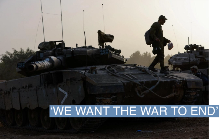An Israeli soldier walks on a tank near the Israel-Gaza border on its Israeli side during a temporary truce between Hamas and Israel, in southern Israel, November 26, 2023. REUTERS/Alexander Ermochenko