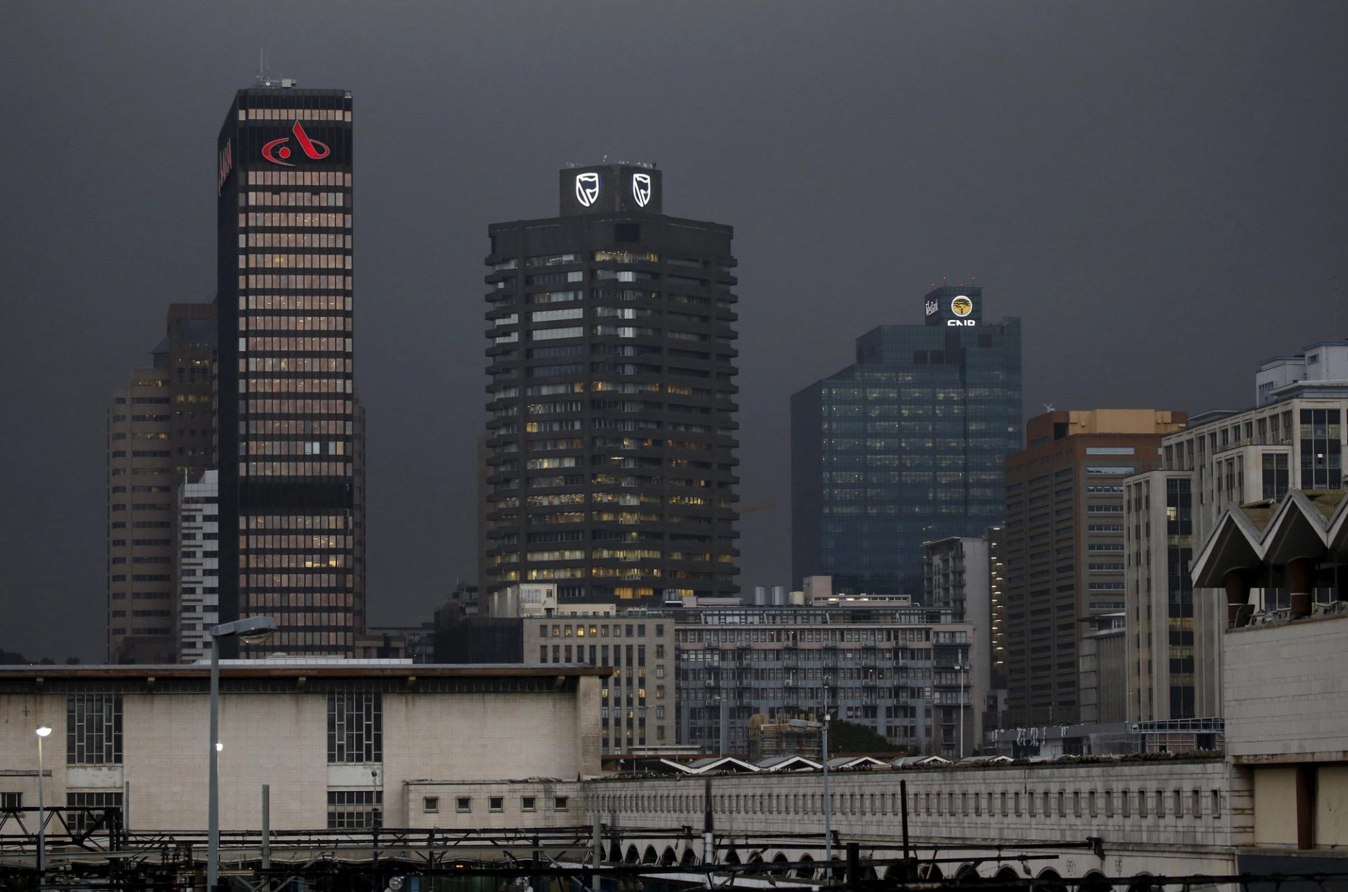 The logos of three South African banks adorn buildings in Cape Town