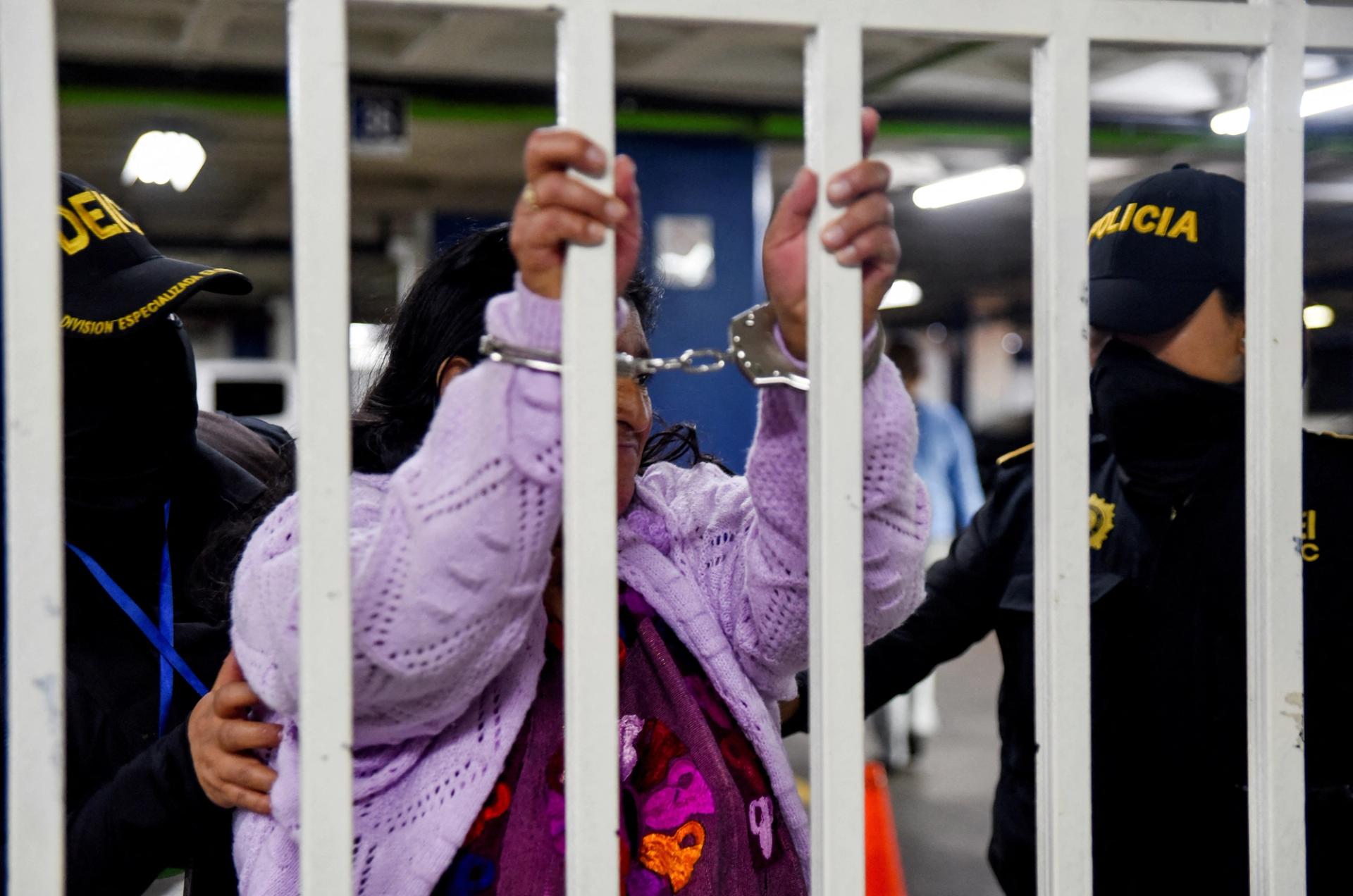 A migrant smuggler is handcuffed by Guatemalan authorities in Guatemala City.