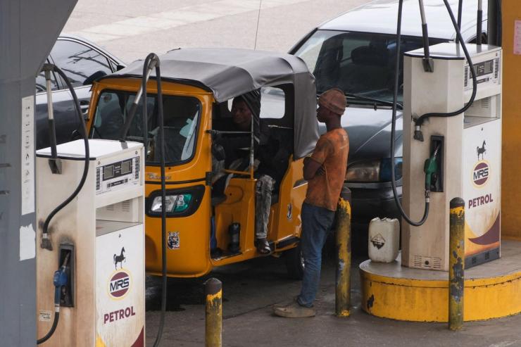 Vehicles queue to purchase fuel at a retail station in Lagos, Nigeria.