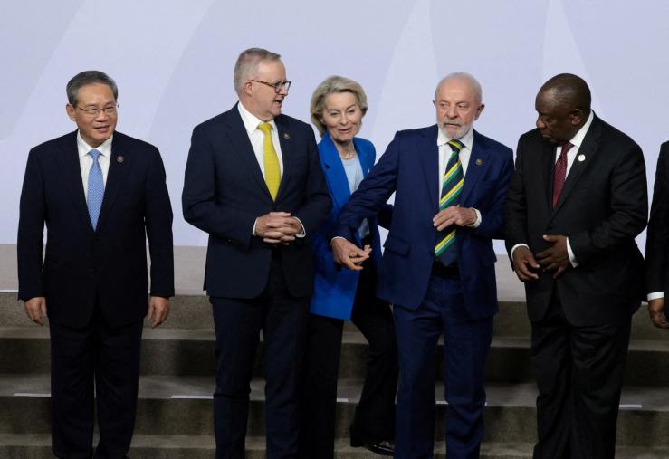 European Commission President Ursula von der Leyen reacts next to Brazil’s President Luiz Inacio Lula da Silva, Australia’s Prime Minister Anthony Albanese, Chinese Premier Li Qiang, and South Africa’s President Cyril Ramaphosa, during a family photo op, on the first day of the G20 Leaders’ Summit at the Nasrec Expo Centre in Johannesburg, South Africa