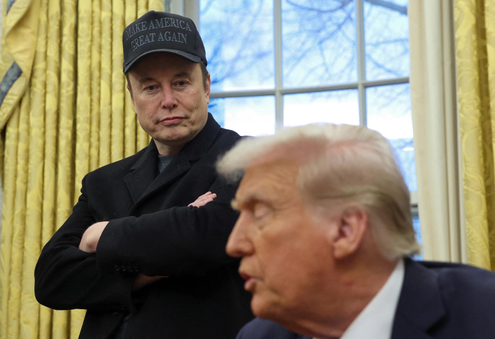 Elon Musk listens to U.S. President Donald Trump speak in the Oval Office of the White House in Washington D.C.