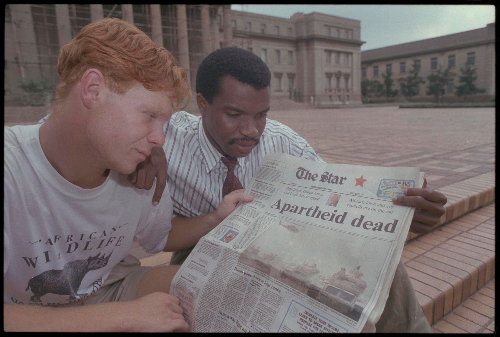 People read the news that apartheid laws will be removed, in Johannesburg, 1991.