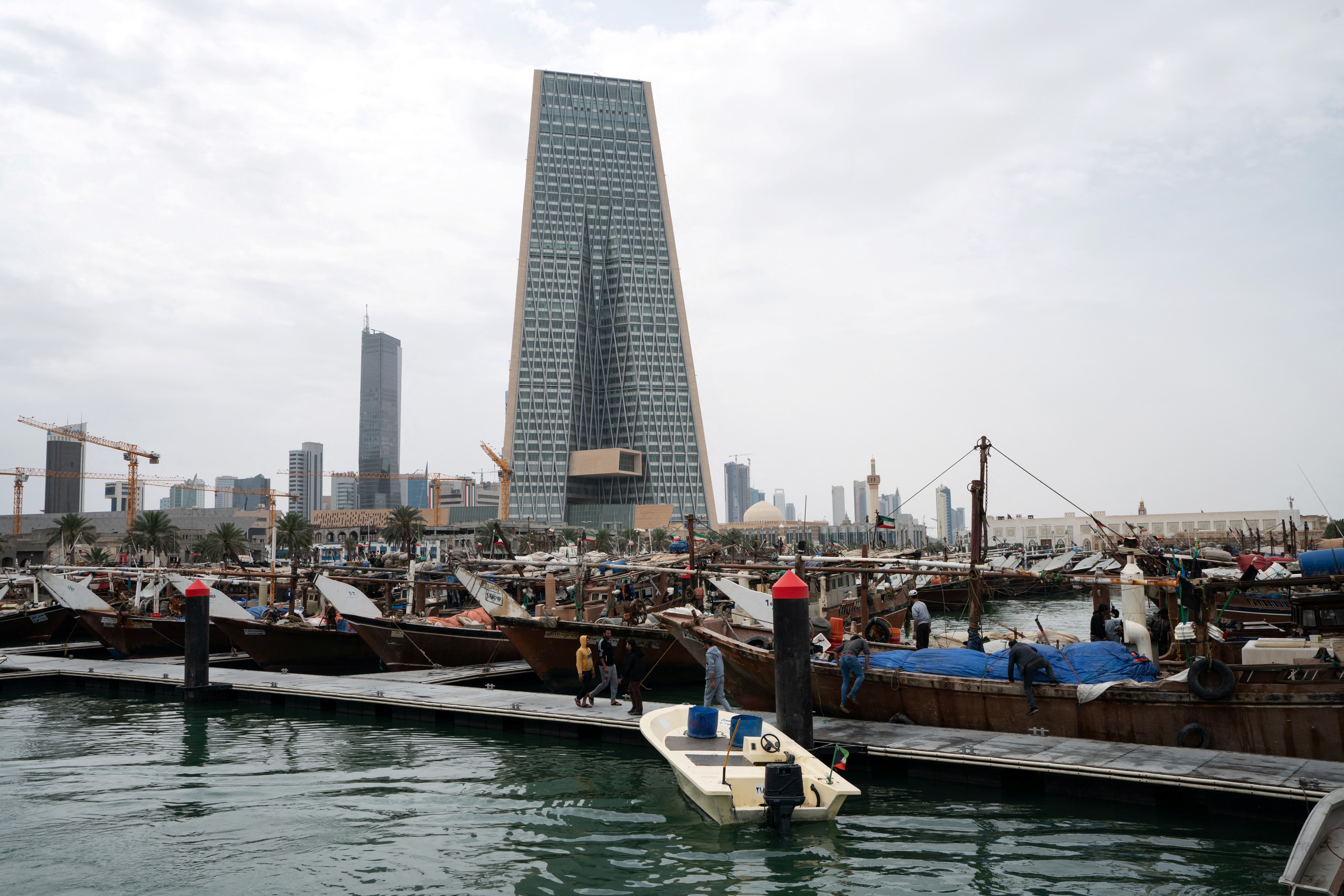 The Kuwait Central Bank towers over the traditional Dhow harbor in Kuwait City.