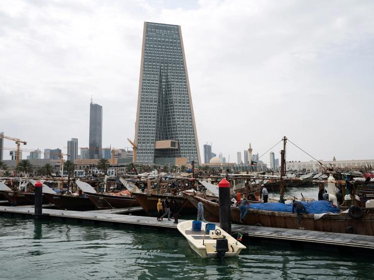 The Kuwait Central Bank towers over the traditional Dhow harbor in Kuwait City.