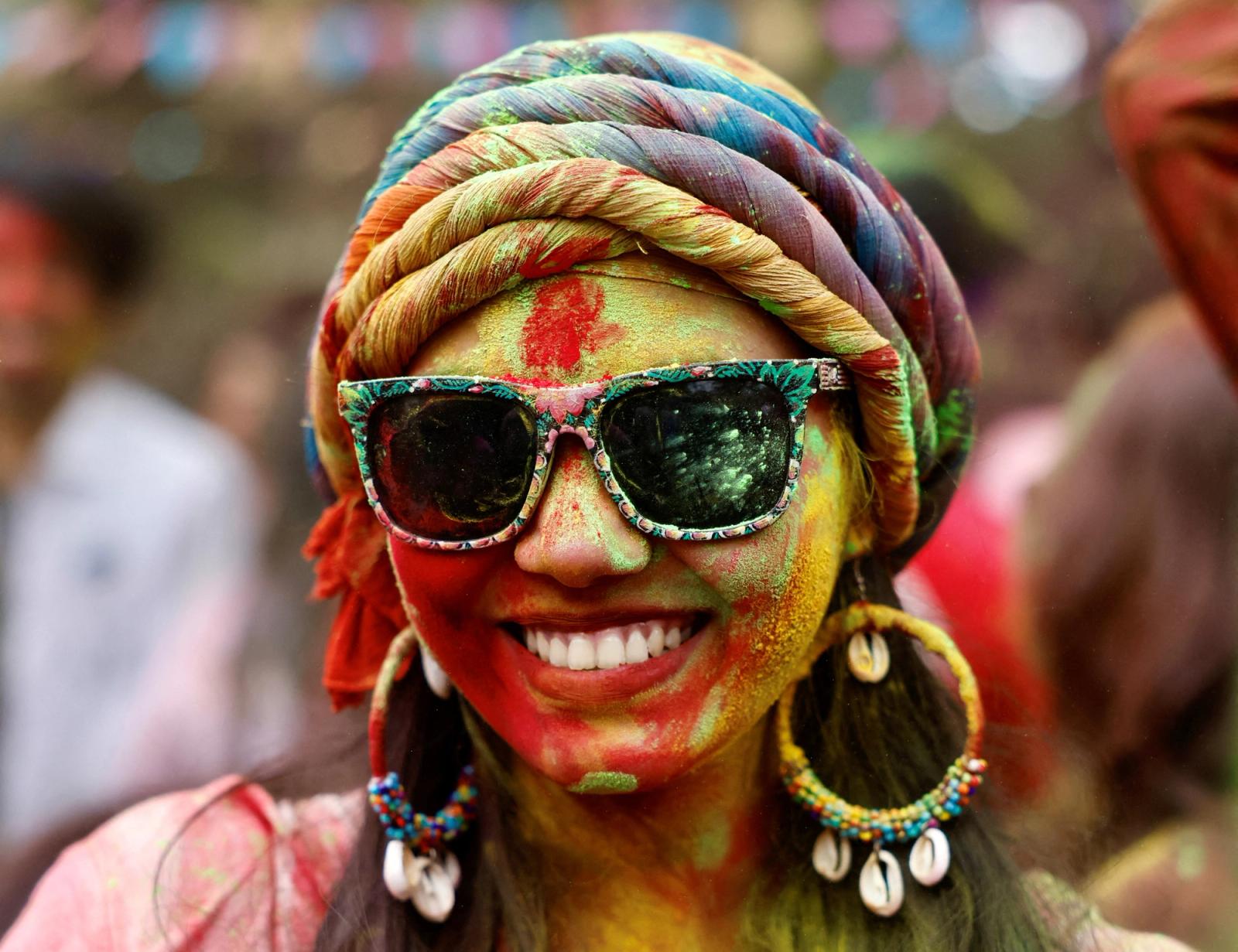 A girl smiles during the celebration of Holi at the Art Department of the University of Dhaka in Dhaka, Bangladesh, March 8, 2023. REUTERS/Mohammad Ponir Hossain