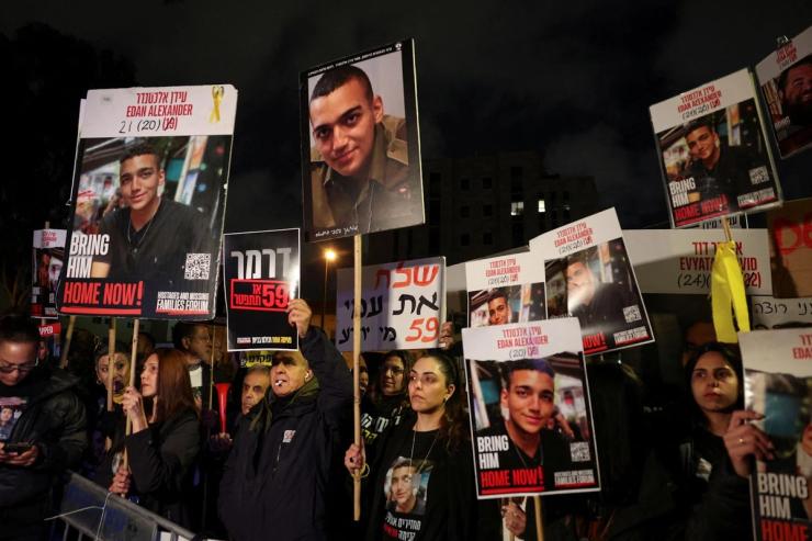 People carry pictures of an Israeli hostage taken by Hamas at a protest in Jerusalem.