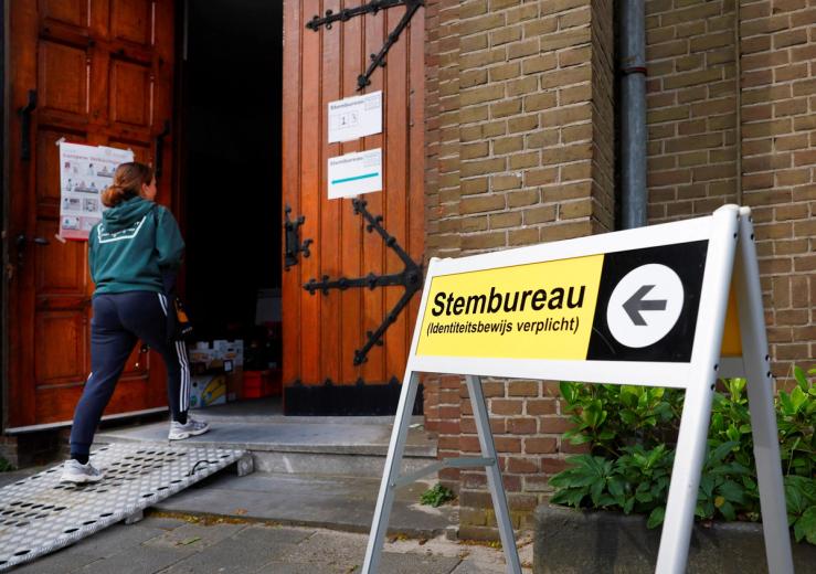 A person walks towards a polling station to vote in the European Union’s parliamentary elections, in Nijmegen, Netherlands, June 6, 2024. REUTERS/Piroschka van de Wouw