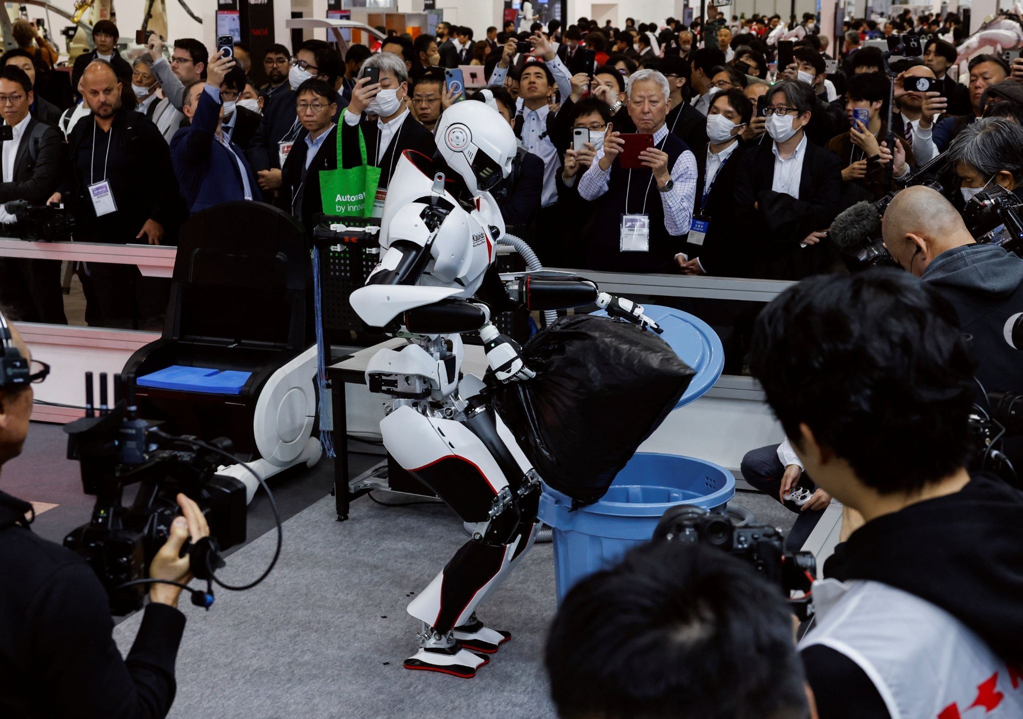 A Kawasaki Heavy Industries robot disposes of trash