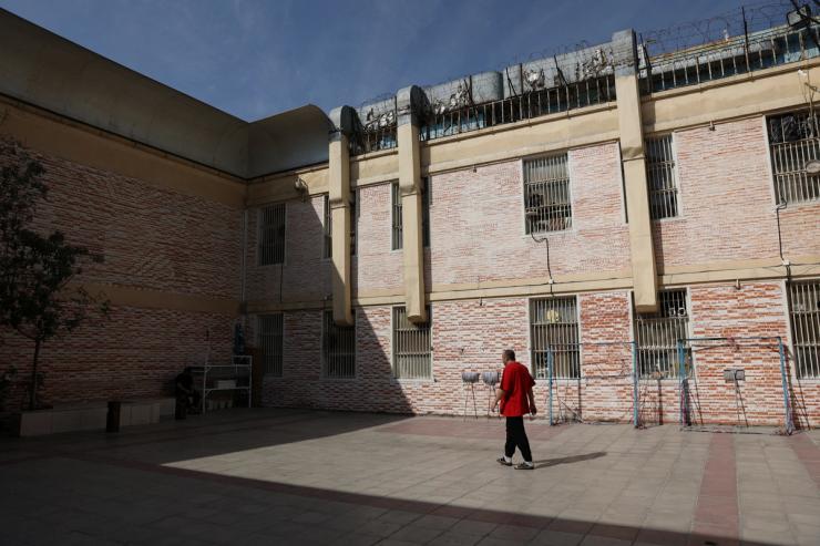 A prisoner walks in the Evin prison yard in Tehran, Iran