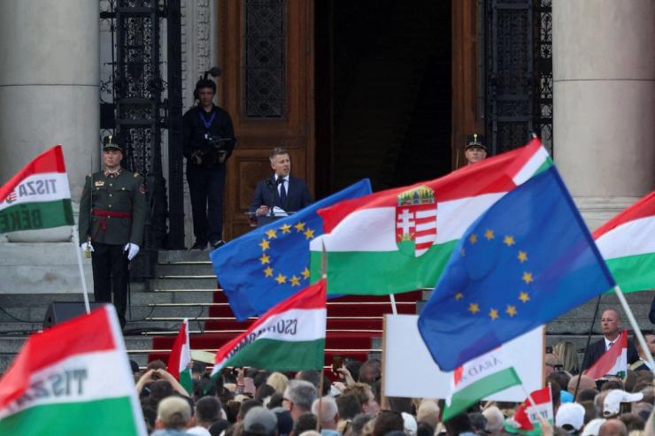 People wave EU and Hungarian flags in front of Hungary’s new PM Péter Magyar.