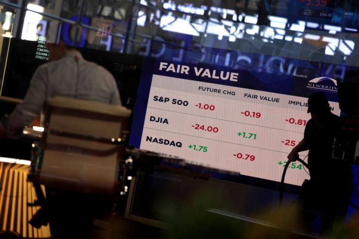 Market data is displayed on a screen inside the Nasdaq market site as US stock markets opened Tuesday following Monday’s broad sell-off in New York City, in March 2025.