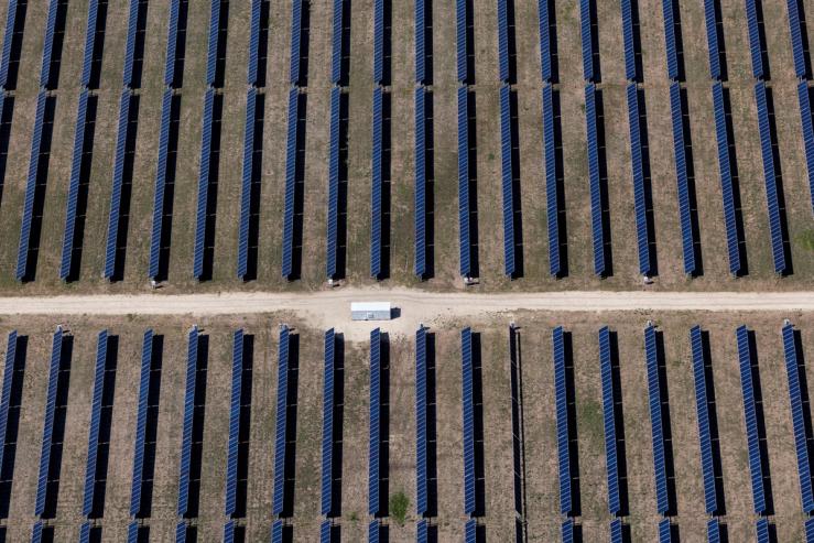 An aerial view shows rows of solar panels at a solar farm in Anson, Texas.
