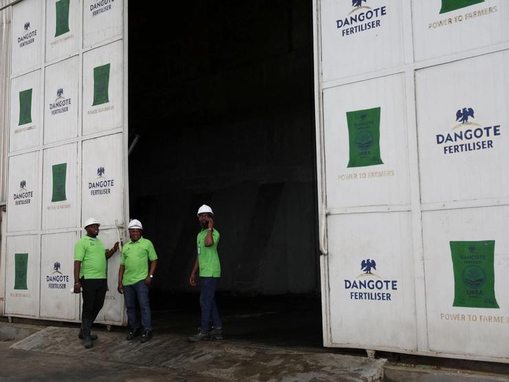 Workers stand at the Dangote Industries oil refinery and fertilizer plant in Nigeria.