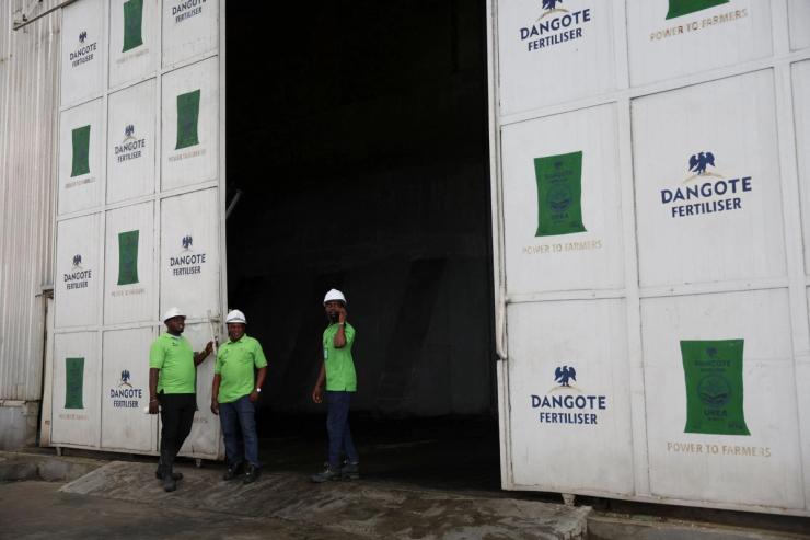 Workers stand at the Dangote Industries oil refinery and fertilizer plant in Nigeria.