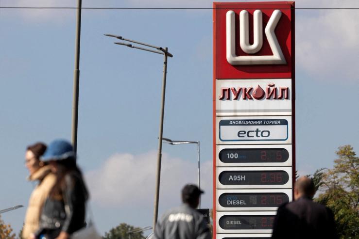 People walk near a Lukoil gas station in Sofia