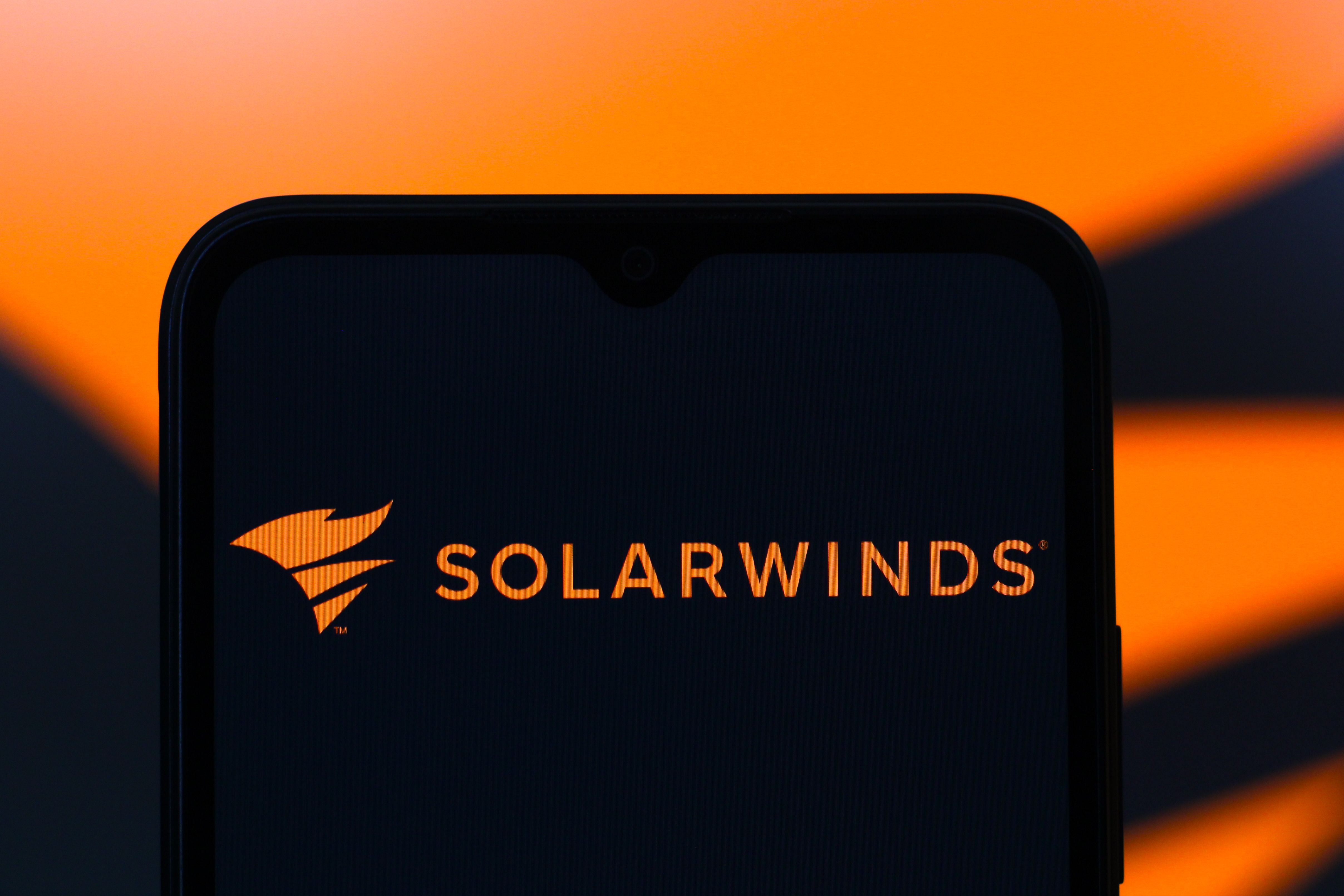 The SolarWinds Corporation logo is seen displayed on a smartphone screen.
