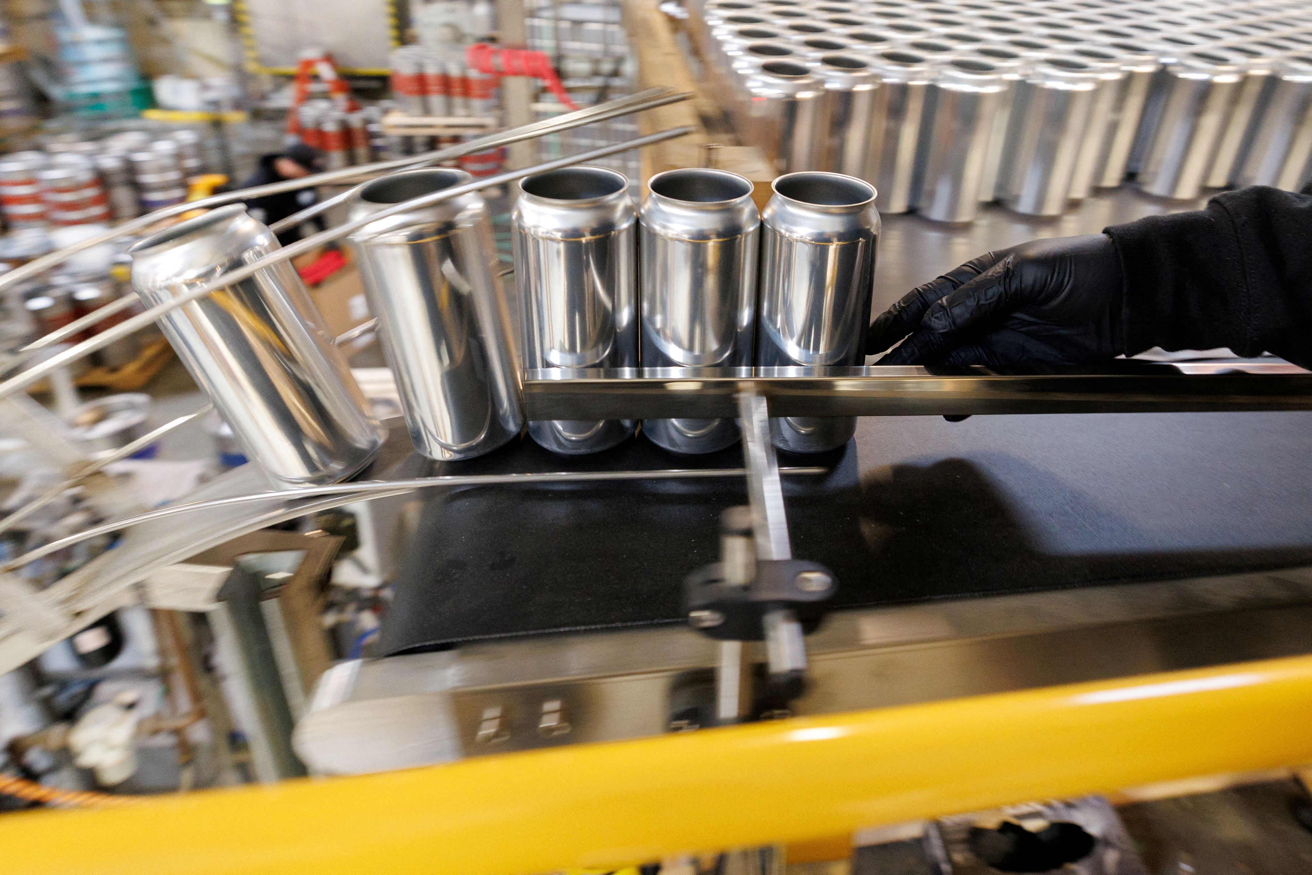 Aluminum cans are shown during a production run.