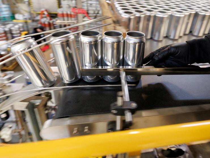 Aluminum cans are shown during a production run.