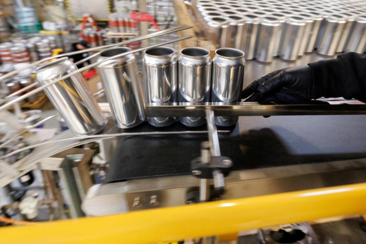 Aluminum cans are shown during a production run.