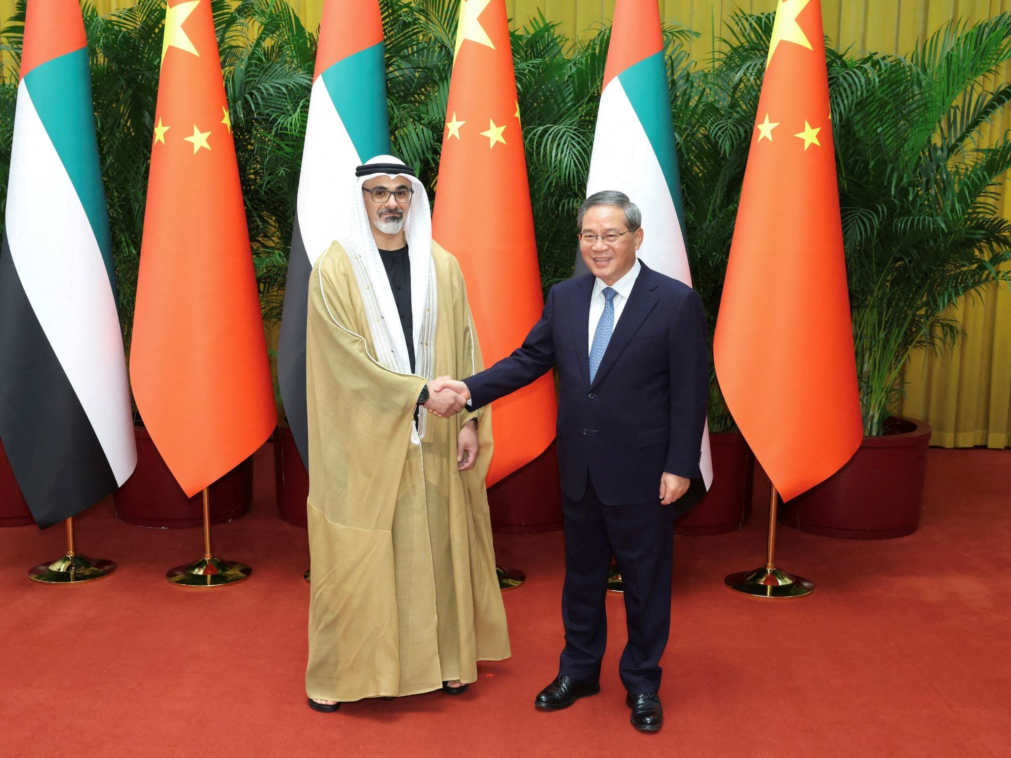 Abu Dhabi Crown Prince Sheikh Khaled bin Mohamed shakes hands with China’s Premier Li Qiang in Beijing on April 13, 2026.