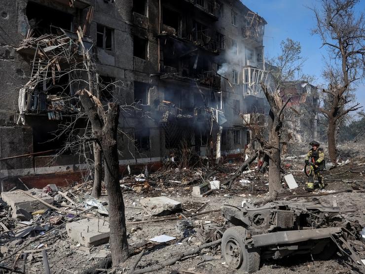 A rescuer works at a site of an apartment building damaged during a Russian air strike, amid Russia’s attack on Ukraine