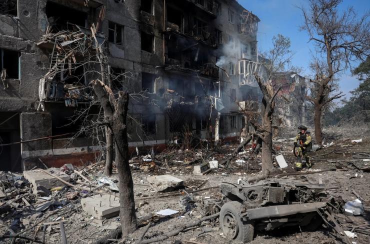 A rescuer works at a site of an apartment building damaged during a Russian air strike, amid Russia’s attack on Ukraine