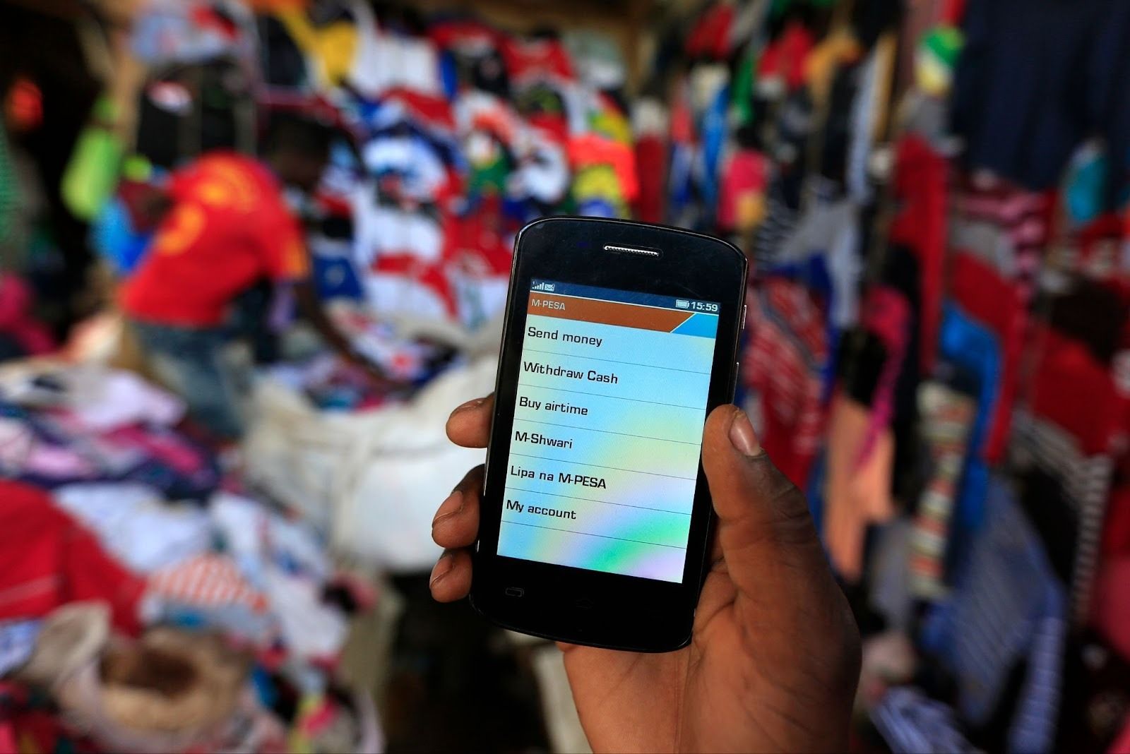 A man holds up his mobile phone showing a M-Pesa mobile money transaction page in Kenya’s capital Nairobi on Dec. 31, 2014.