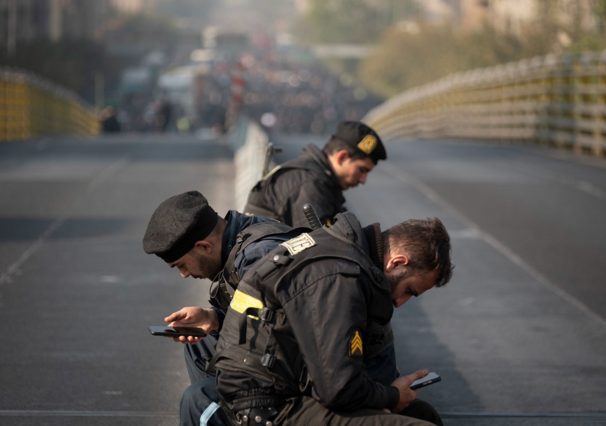 Iranian policemen on their phones in 2025.