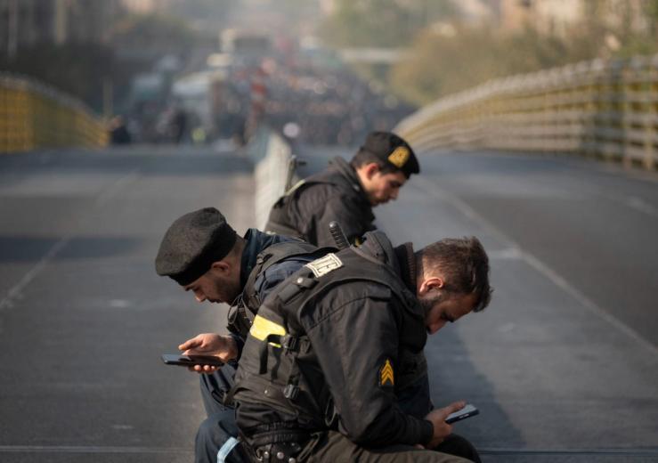 Iranian policemen on their phones in 2025.