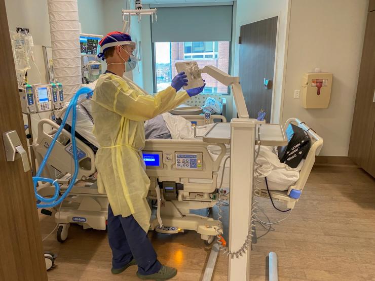 Nurse Matt Robinson, Patient Care Coordinator at the Methodist University Hospital COVID-19 Unit, tends to the coronavirus disease (COVID-19) patients as the hospital prepares for the distribution of the Pfizer vaccine in Memphis, Tennessee