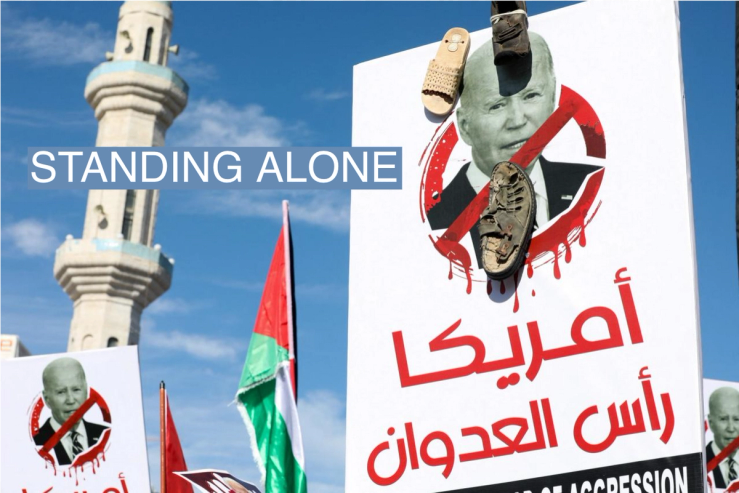 A person holds a placard with a crossed out picture of U.S. President Joe Biden and shoes attached to it, during a protest in support of Palestinians in Gaza, in Amman, Jordan December 8, 2023.