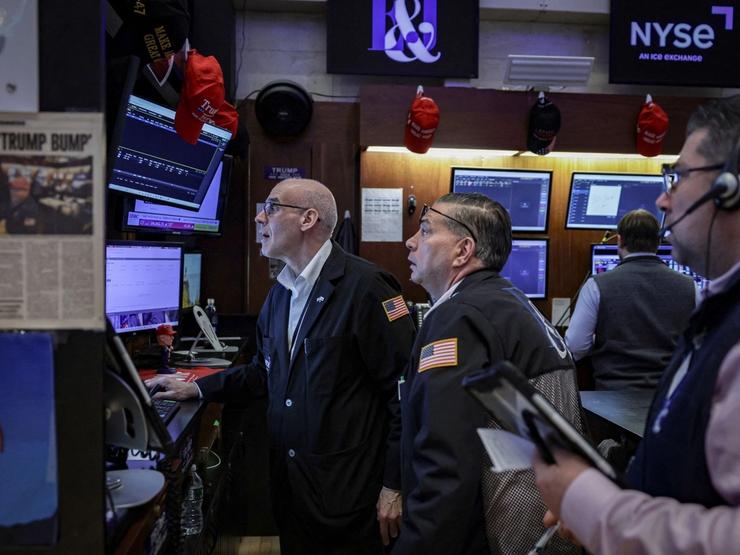 Traders work on the floor at the New York Stock Exchange (NYSE) in New York City
