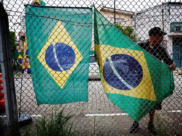 A vendor displays Brazilian flags before a campaign event with Presidential candidate Flavio Bolsonaro.