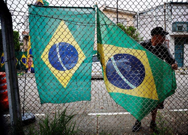 A vendor displays Brazilian flags before a campaign event with Presidential candidate Flavio Bolsonaro.