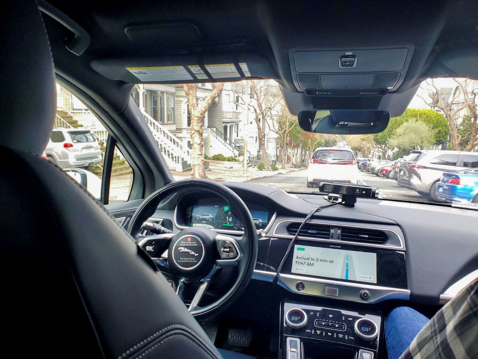 Photo from inside a driverless car showing the empty driver’s seat.