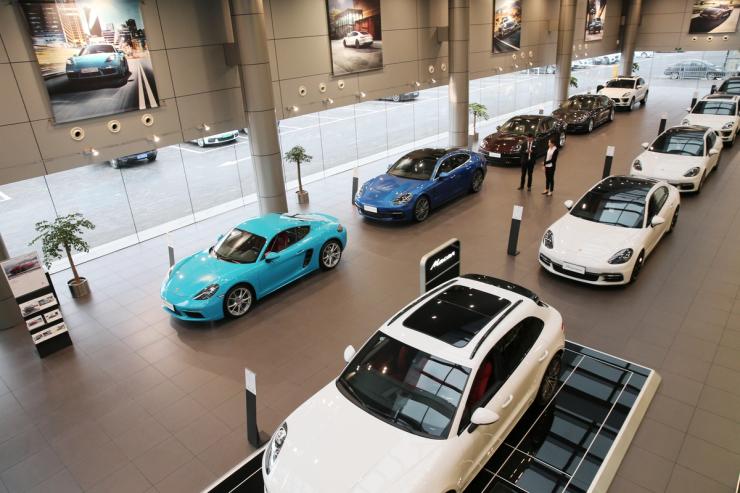 Imported Porsche cars are seen inside a showroom in Nantong, Jiangsu province, China
