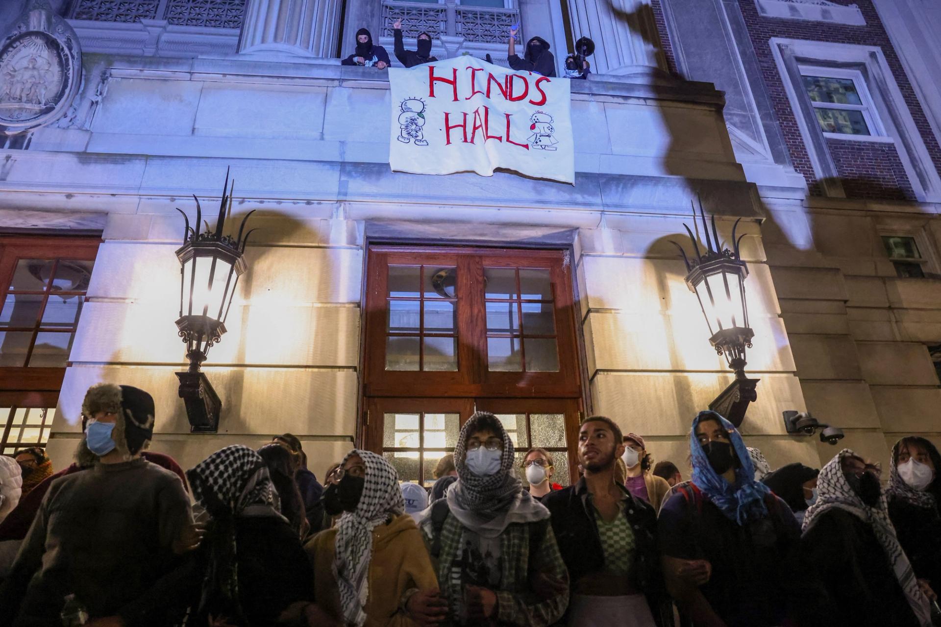 Protesters link arms outside Hamilton Hall barricading students inside the building at Columbia University on April 30, 2024.
