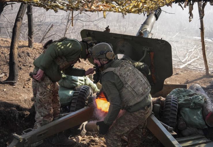 Ukrainian National Guard fire a howitzer toward Russian troops near the front.