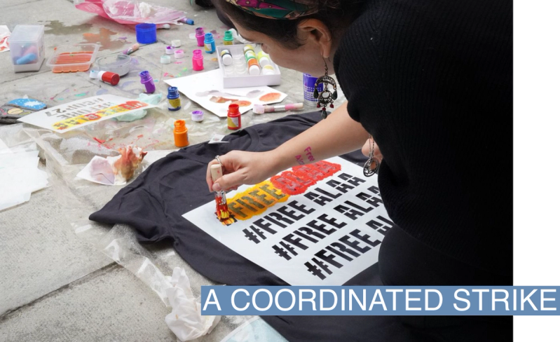 Alaa Abdel-Fattah’s sister stencils a t-shirt during a protest in solidarity with Alaa outside the British Foreign Office on October 30, 2022.