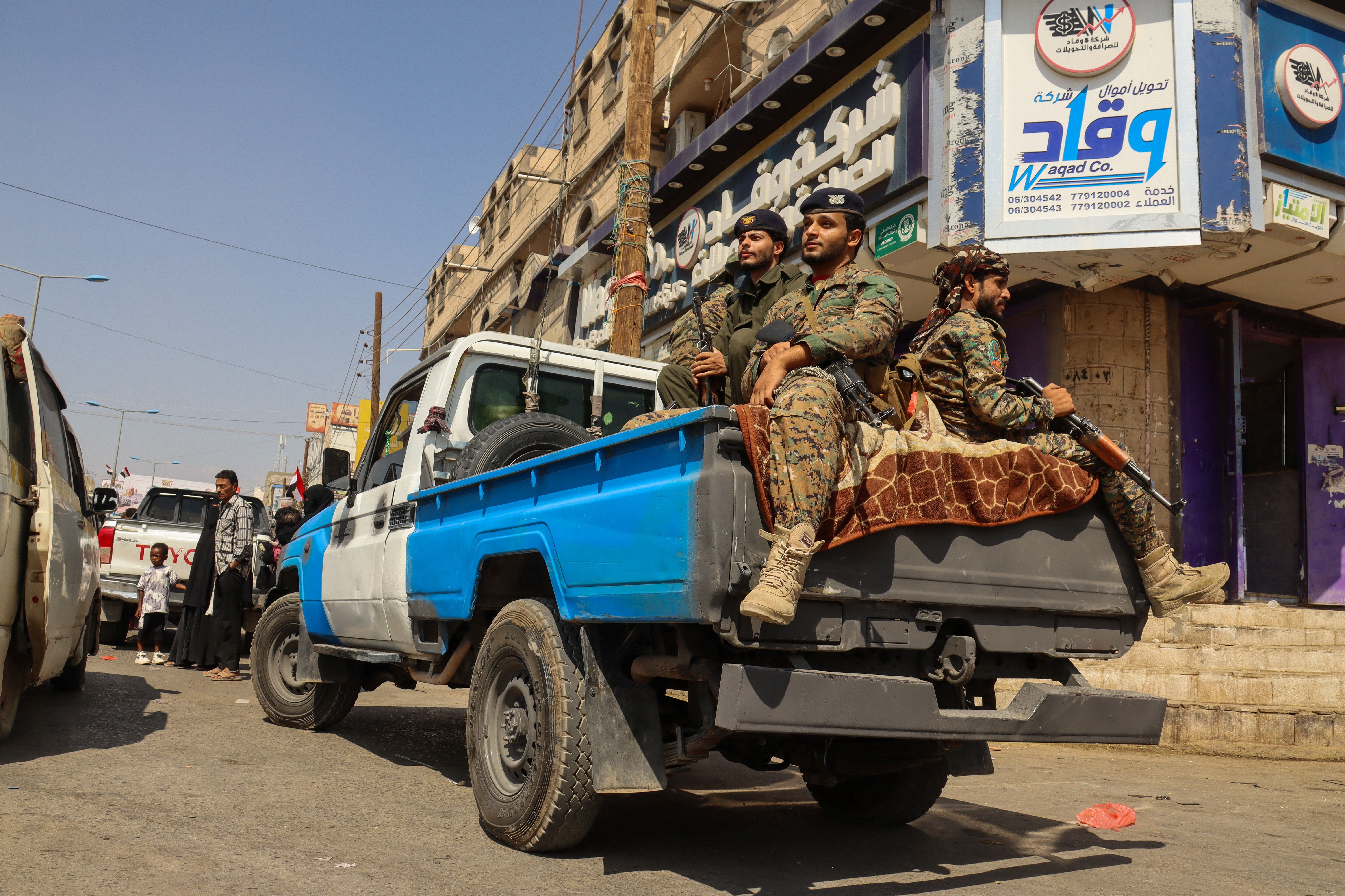 Police troopers patrol a street in Marib
