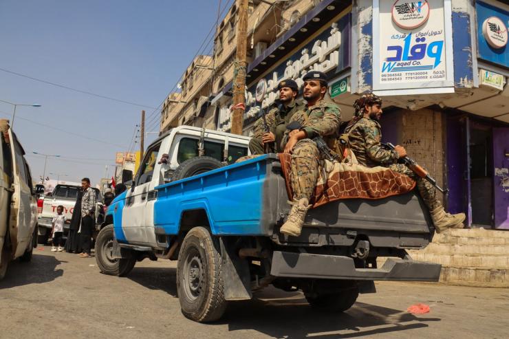 Police troopers patrol a street in Marib