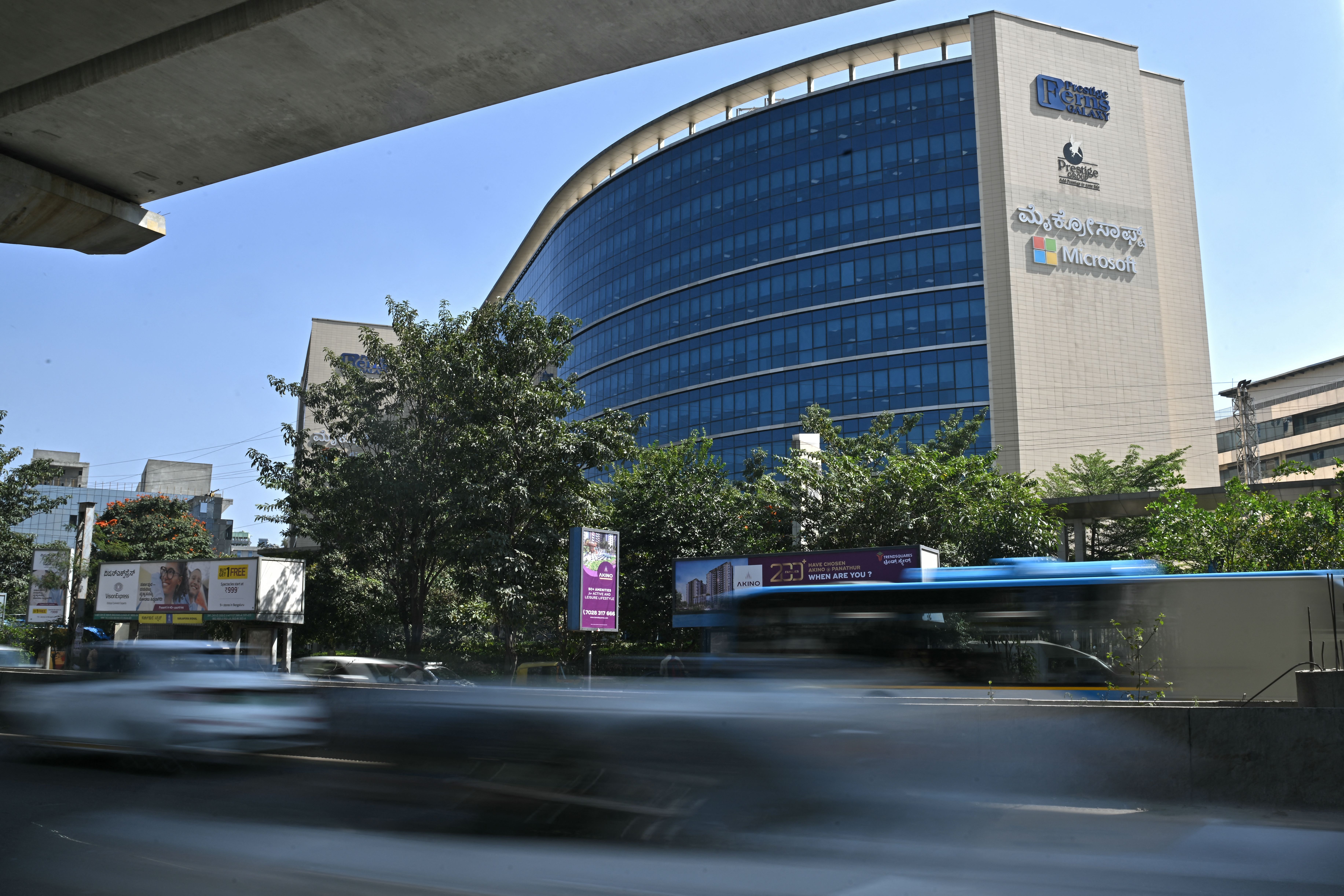 Commuters drive past the Microsoft office in Bengaluru