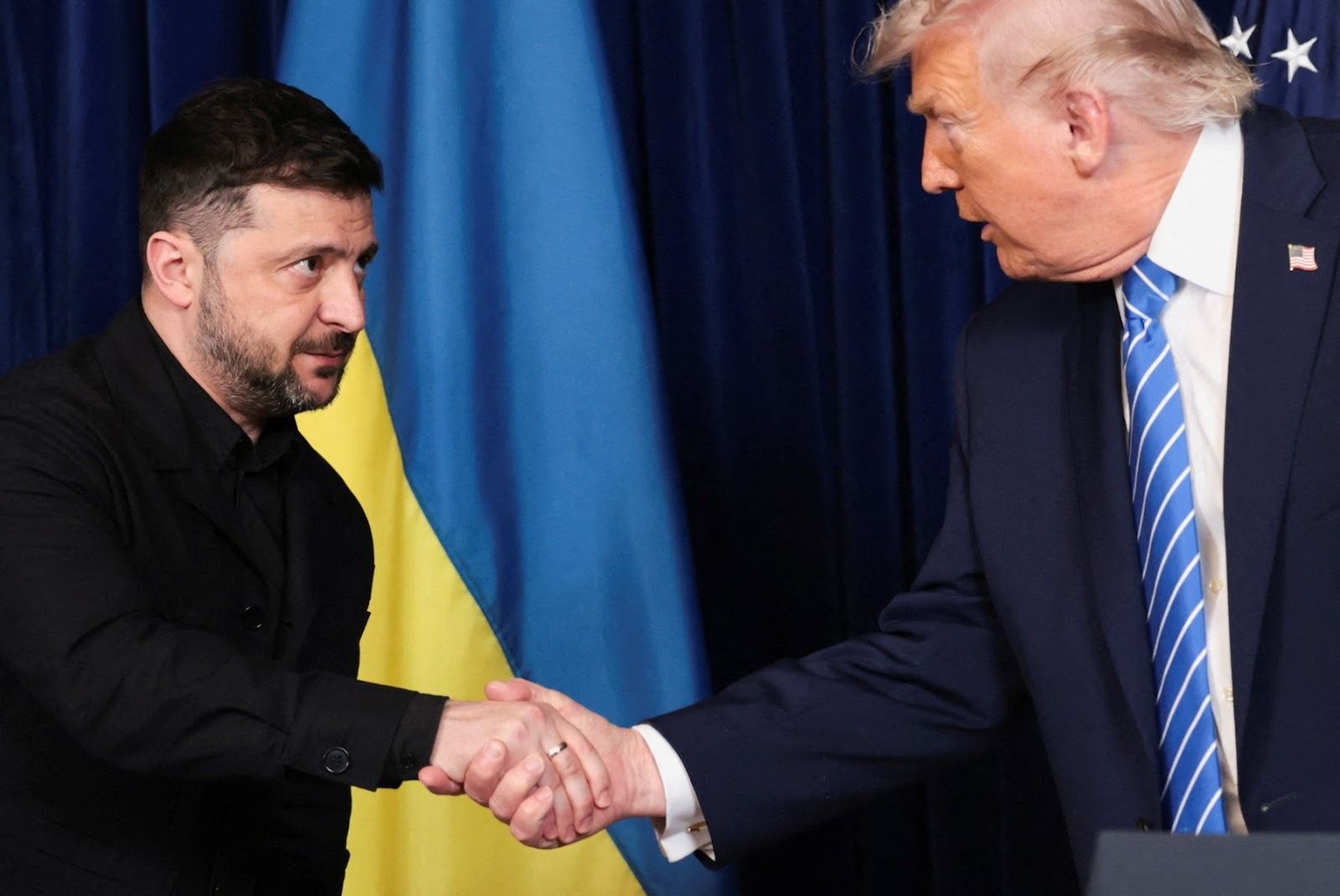 Zelenskyy and Trump shaking hands. 
